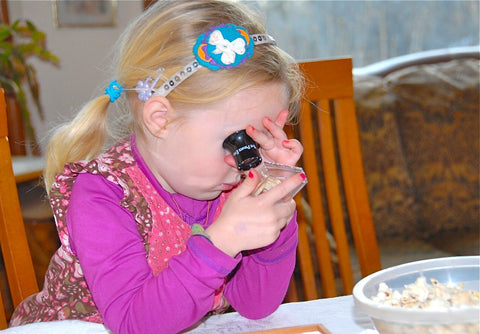 Introducing Pre-Kindergartners to The Private Eye with girl using loupe